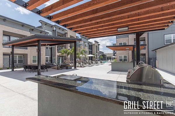 Outdoor grilling station, dining area, and poolside seating. Click to view the photo gallery.