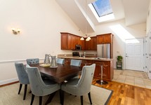 Large kitchen with vaulted ceiling and skylight