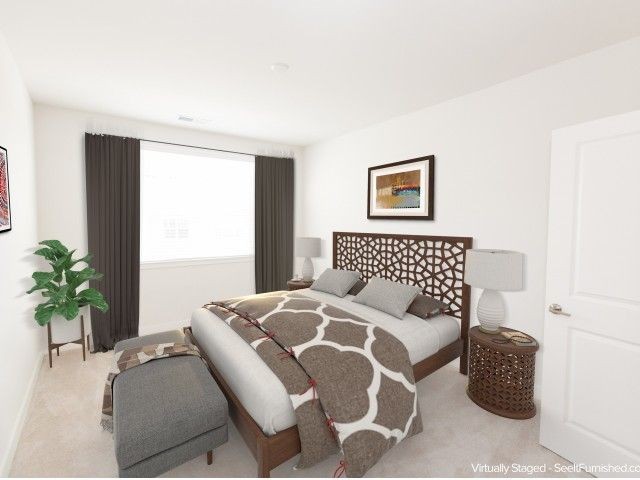 Large bedroom with neutral colored bedding, large window