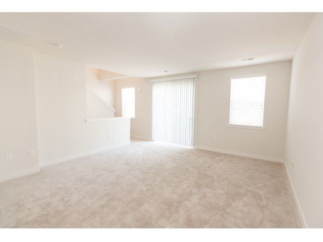 living room floor, light colored beige carpet