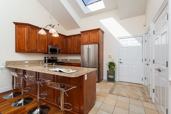 Kitchen with bar seating and granite countertops. Click to view the photo gallery.