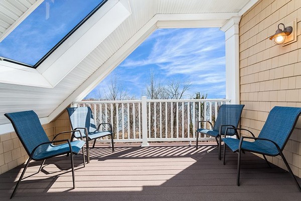 Private patio with blue lounge chairs and large skylight. Click to view the photo gallery.