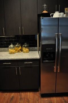 apartment kitchen with stainless fridge