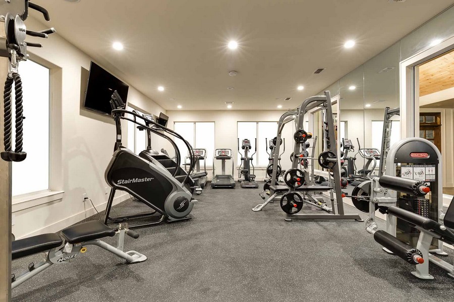 Fitness room with weights, stair machines, and treadmills