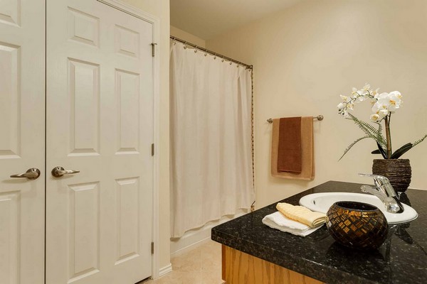 Bathroom with granite countertops and large closet doors. Click to view the photo gallery.