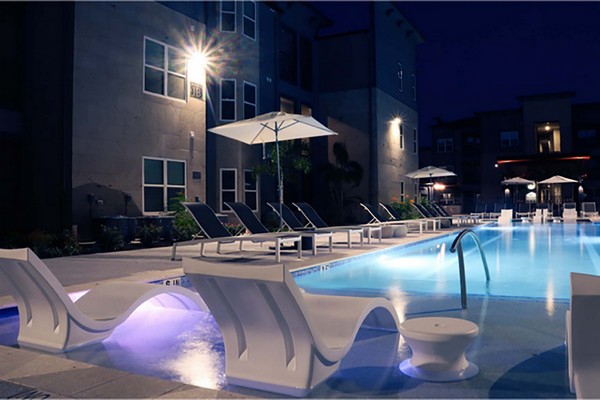 Night view of tanning ledge, swimming pool, and sun deck. Click to view the photo gallery.