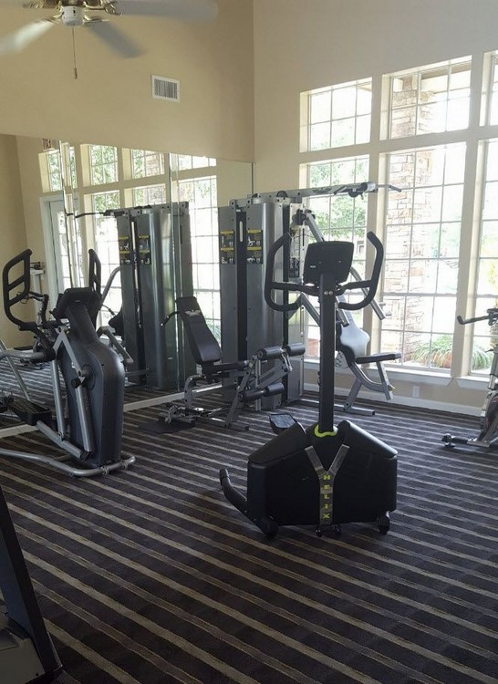 View of apartment gym area with exercise equipment