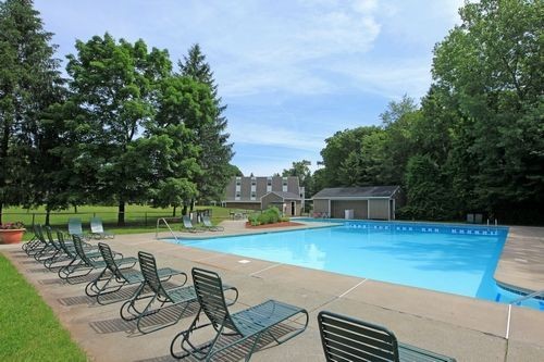 Outdoor pool with pool chairs. Click to view the photo gallery.