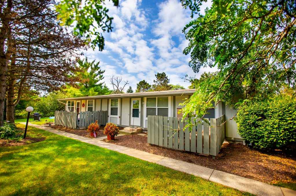 exterior of property, sidewalk, trees and grass