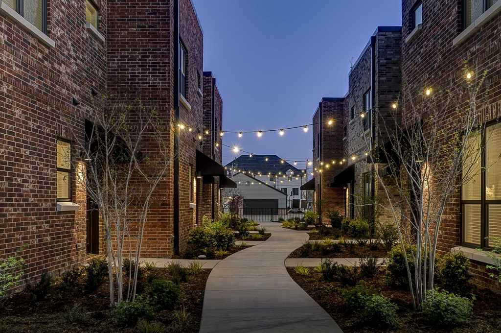 Winding sidewalk and landscaping between tenant buildings.