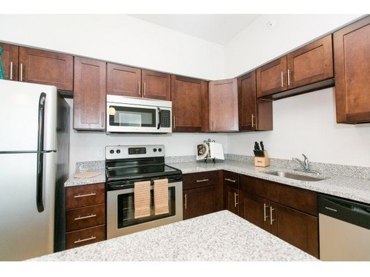kitchen cabinetry and counters that line two walls. Click to view the photo gallery.
